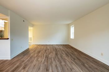 a bedroom with hardwood floors and white walls  at Charlesgate Apartments, Maryland, 21204